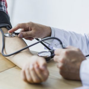 crop-doctor-measuring-blood-pressure-of-patient_23-2147896723